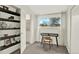 Bright bedroom featuring neutral tones, a modern desk near the window, and an open closet with floating shelves at 8055 E Colorado Ave # 8, Denver, CO 80231
