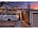 Townhouse exterior with a private entrance, steps to the front door, and adjacent garage at dusk at 8055 E Colorado Ave # 8, Denver, CO 80231