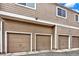 Exterior view of multiple attached garages with matching doors at 8055 E Colorado Ave # 8, Denver, CO 80231