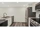 Modern kitchen features stainless steel appliances, granite countertops, and white cabinetry at 8055 E Colorado Ave # 8, Denver, CO 80231