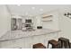 This modern kitchen features granite countertops, stainless steel appliances and bar stool seating at 8055 E Colorado Ave # 8, Denver, CO 80231