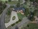 Aerial view of a multi-story home with circular driveway, lush landscaping and surrounding trees at 22081 Paradise Cir, Golden, CO 80401