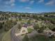 Expansive aerial view of home nestled among trees, showcasing mountain views and neighborhood at 22081 Paradise Cir, Golden, CO 80401