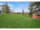 Expansive backyard with mature trees and lush green grass, offering space and natural beauty at 22081 Paradise Cir, Golden, CO 80401