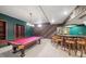 A basement bar and game room complete with a pool table, lighting, and bar stools at 22081 Paradise Cir, Golden, CO 80401