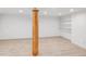 Spacious unfinished basement with light flooring, white walls, support beam, and shelving at 22081 Paradise Cir, Golden, CO 80401
