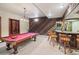 Basement featuring a pool table, bar and wood paneled wall at 22081 Paradise Cir, Golden, CO 80401