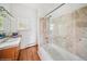 Bathroom showcasing a glass-enclosed tub with decorative tile and marble vanity at 22081 Paradise Cir, Golden, CO 80401