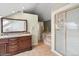 Bathroom with double vanity, granite counters, walk-in shower with glass doors, and tile flooring at 22081 Paradise Cir, Golden, CO 80401