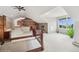 Spacious bedroom with a stone fireplace, unique architecture, and large windows showcasing beautiful outdoor views at 22081 Paradise Cir, Golden, CO 80401