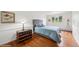 Cozy bedroom with hardwood floors, queen bed, wainscotting, and bright windows at 22081 Paradise Cir, Golden, CO 80401