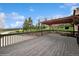 A spacious wooden deck featuring a wooden pergola and overlooking a green landscape at 22081 Paradise Cir, Golden, CO 80401