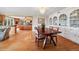 Bright dining area with wood floors, decorative china cabinet, wood table, and chairs at 22081 Paradise Cir, Golden, CO 80401