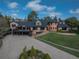 Charming two-story brick home with a deck, lush lawn and mature trees surrounding the property at 22081 Paradise Cir, Golden, CO 80401