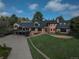 Charming two-story brick home with a deck, lush lawn and mature trees surrounding the property at 22081 Paradise Cir, Golden, CO 80401
