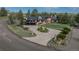 Stately brick home features a circular driveway, professional landscaping, mature trees, and multiple outdoor living spaces at 22081 Paradise Cir, Golden, CO 80401