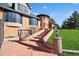 Stunning home exterior showcasing brickwork, unique architectural details, and a well-manicured lawn at 22081 Paradise Cir, Golden, CO 80401