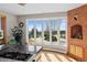 Bright kitchen with a large bay window, views of the greenery, and a brick accent wall at 22081 Paradise Cir, Golden, CO 80401