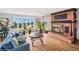 Inviting living room with a brick fireplace, large windows, and a comfortable blue sofa at 22081 Paradise Cir, Golden, CO 80401