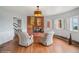 Bright living room with a brick fireplace, hardwood floors, and an abundance of natural light at 22081 Paradise Cir, Golden, CO 80401
