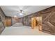 Open living room with stairs, unique wood paneling, and an entryway with forest mural at 22081 Paradise Cir, Golden, CO 80401
