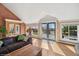 Open living area with a cozy brown sofa, large windows, and access to an outdoor deck at 22081 Paradise Cir, Golden, CO 80401