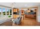Open-concept living space with hardwood floors, a fireplace, and a view into the eat-in kitchen at 22081 Paradise Cir, Golden, CO 80401