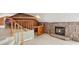 Cozy living space with a stone fireplace, a bar area, and a staircase leading to the upper level at 22081 Paradise Cir, Golden, CO 80401