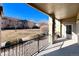 This spacious balcony features an iron railing overlooking a lush, green yard at 2239 Calais Dr # E, Longmont, CO 80504