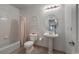 This bathroom is equipped with a shower over tub and pedestal sink at 2239 Calais Dr # E, Longmont, CO 80504