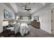 This primary bedroom features a tray ceiling, ceiling fan, a large window and a walk in closet at 2239 Calais Dr # E, Longmont, CO 80504