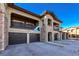 Beautiful townhome featuring stone accents, a private balcony, and attached garages at 2239 Calais Dr # E, Longmont, CO 80504