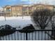 Building exterior view showcasing landscaping and snow at 2239 Calais Dr # E, Longmont, CO 80504