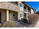 Inviting condo exterior with stone accents, neutral siding, manicured bushes, and a welcoming front door at 2239 Calais Dr # E, Longmont, CO 80504