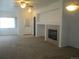 Spacious living room featuring a fireplace and carpet at 2239 Calais Dr # E, Longmont, CO 80504