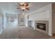 Cozy living room with a fireplace and view of the front entrance and window at 2239 Calais Dr # E, Longmont, CO 80504