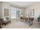 Well-lit home office with minimalist decor, plush chair, and sleek desk positioned beneath bright window at 2792 Greatwood Way, Highlands Ranch, CO 80126