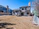 Back exterior view of the home with a spacious backyard and a mature tree line at 22 S Indiana Pl, Golden, CO 80401