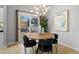 Stylish dining area featuring a modern chandelier, backyard view and seating for four at 22 S Indiana Pl, Golden, CO 80401