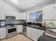 Updated kitchen with stainless steel appliances, white cabinets, and stylish backsplash tile at 22 S Indiana Pl, Golden, CO 80401