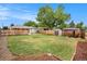Spacious backyard with a large grassy area, shed, patio and privacy fence at 5100 Clay St, Denver, CO 80221