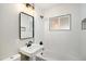 Bathroom featuring a white vanity, shower and a black framed mirror and window at 5100 Clay St, Denver, CO 80221