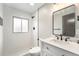 Updated bathroom features a walk-in shower, modern fixtures, and a sleek vanity with granite countertop at 5100 Clay St, Denver, CO 80221