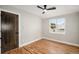 Cozy bedroom with hardwood floors, ceiling fan, and large windows for ample light at 5100 Clay St, Denver, CO 80221