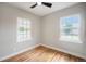 Bedroom featuring beautiful wood floors, a ceiling fan and two windows at 5100 Clay St, Denver, CO 80221