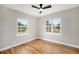 Bright bedroom featuring beautiful wood floors, a ceiling fan and two windows at 5100 Clay St, Denver, CO 80221