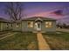 Charming home featuring a well-manicured lawn and inviting facade at dusk at 5100 Clay St, Denver, CO 80221
