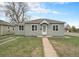 Charming single-story home with meticulous landscaping, well-maintained lawn, and a welcoming front porch at 5100 Clay St, Denver, CO 80221