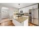 Modern kitchen features white cabinetry, stainless steel appliances, and a granite-topped island at 5100 Clay St, Denver, CO 80221