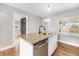 Kitchen island with stainless steel dishwasher, sink, and neutral countertop at 5100 Clay St, Denver, CO 80221